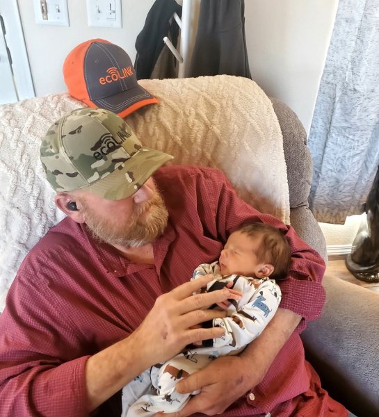 Steve and new grandson Archer - Proud Grandpa holding newest Grandson!